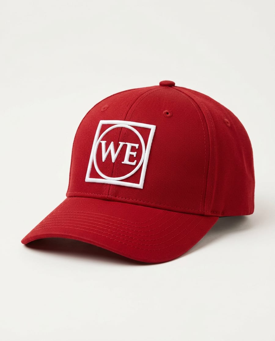 Red six-panel cap with a raised white WE monogram