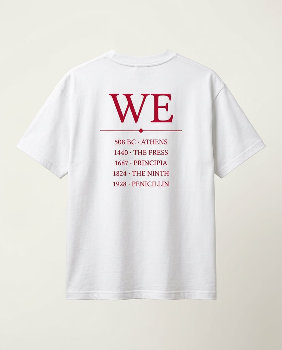 Back of a white tee printed in red with WE and a five-line timeline