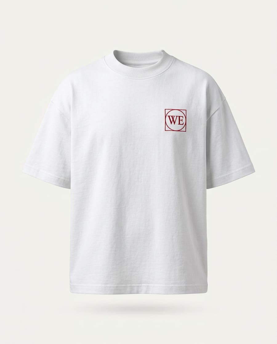 White heavyweight tee with a small red WE monogram embroidered on the chest